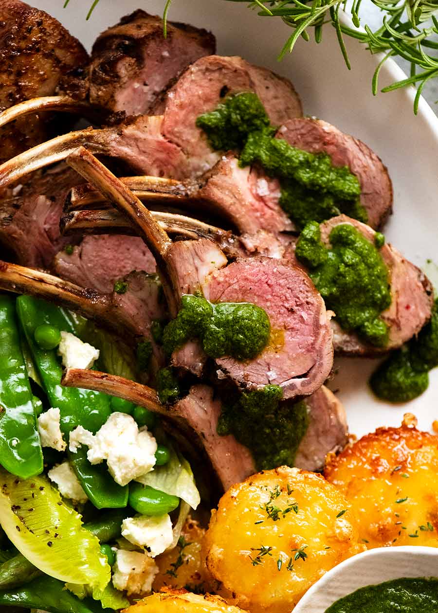 Close up of Rack of Lamb slices on a plate served with salsa verde