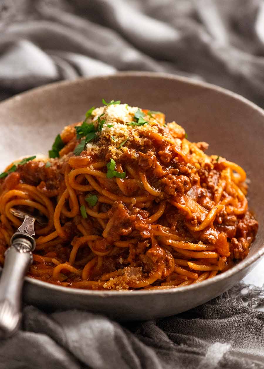 Bowl of One Pot Pasta Bolognese garnished with parmesan, ready to be eaten