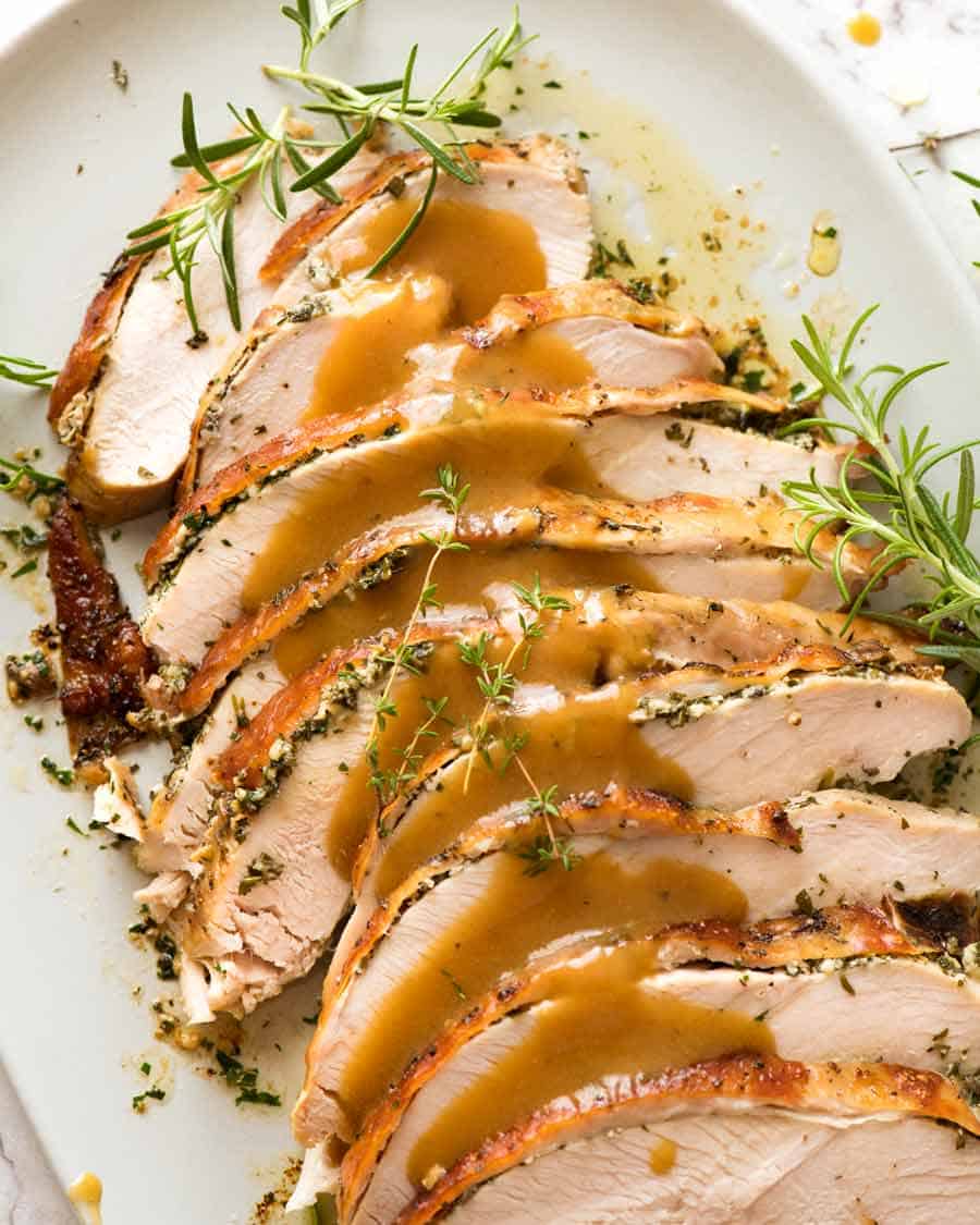 Slices of Garlic Herb Slow Cooker Turkey Breaston a plate, ready to be served