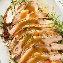 Slices of Slow Cooker Garlic Herb Turkey Breast on a plate, ready to be served